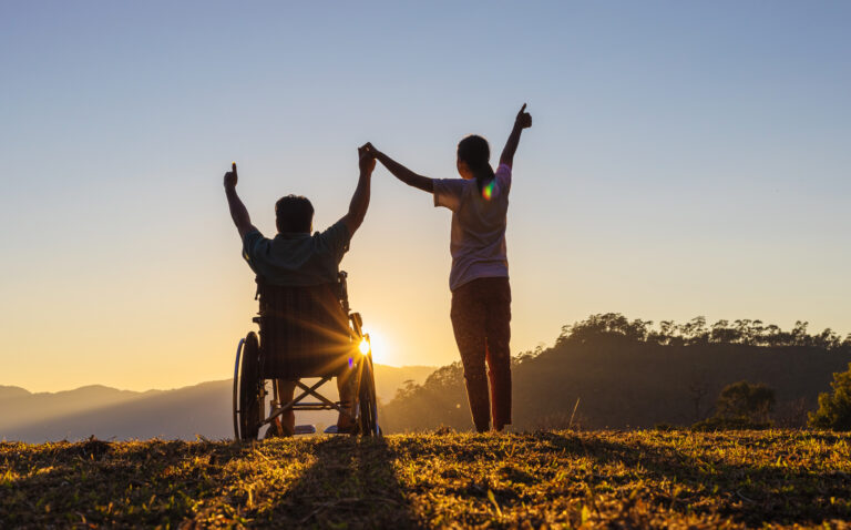 NDIS disability support worker and NDIS participant greeting the sun