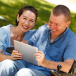 NDIS support worker and customer viewing a document