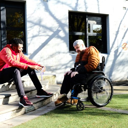 NDIS support worker and customer talking outside